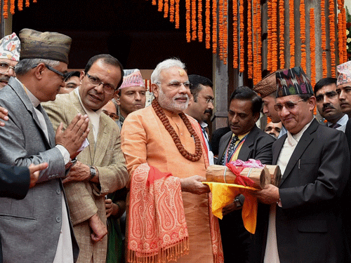 Prime Minister Narendra Modi gifts sandalwood to the Pashupatinath temple after praying at the temple in Kathmandhu, Nepal on Monday. PTI Photo