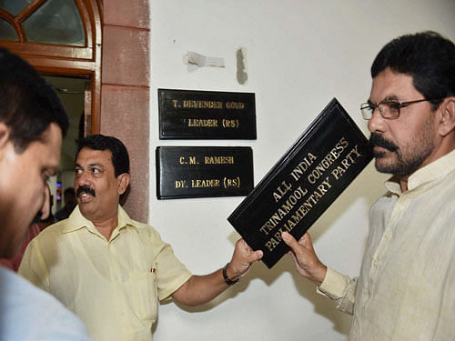 TDP MPs holding a nameplate of AITMC that was put up at Room No. 5 in Parliament in New Delhi. MPs of Trinamool Congress and Telegu Desam Party were engaged in a scuffle in Parliament over the office space. PTI photo