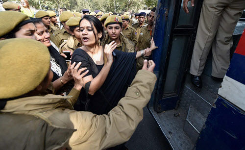 Police take away JNU students who were demonstrating ouside the office of Akhil Bharat Hindu Mahasabha against their Valentine's Day diktat, in New Delhi on Saturday. PTI Photo