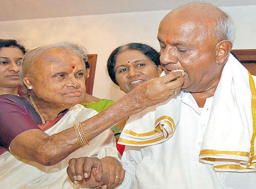 Chennamma Deve Gowda offers sweet to her husband, former prime minister H D Deve Gowda, on his 84th birthday celebration at his residence at Padmanabha Nagar in Bengaluru on Wednesday.