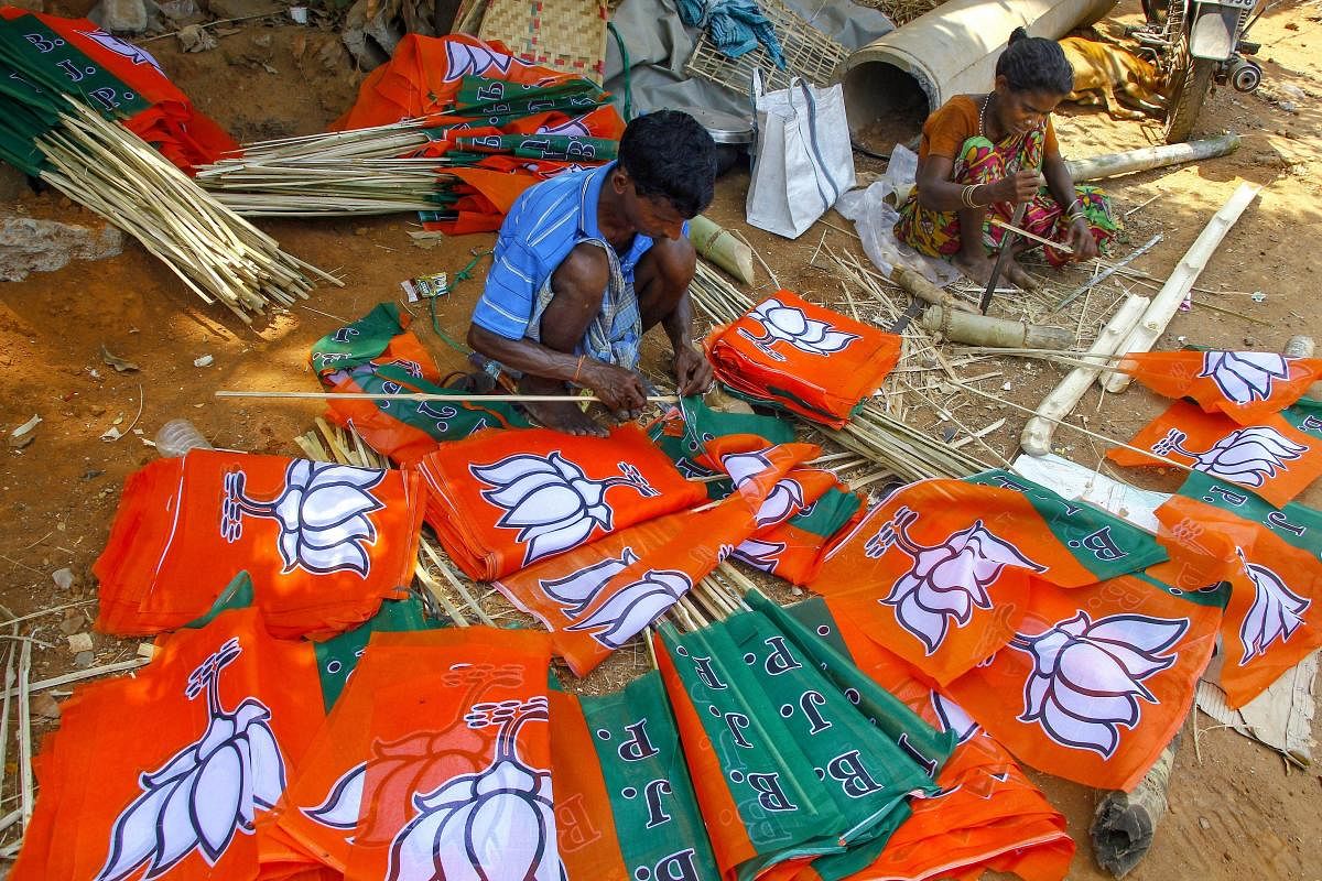 Workers prepare BJP party flags ahead of General Elections 2019, in Bhubaneswar, Tuesday, March 12, 2019. PTI Photo for representation. 