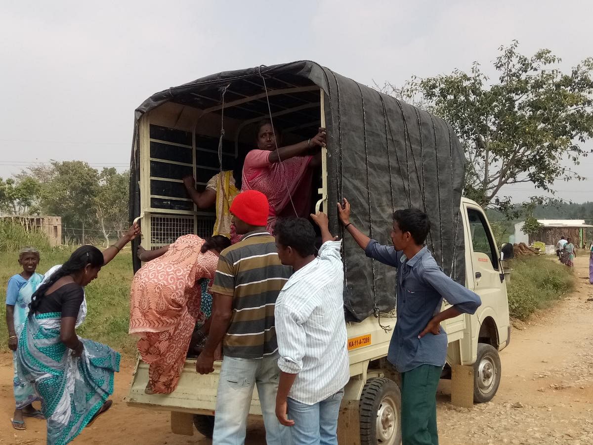 Villagers board a goods autorickshaw at Vadesamudra village, in Pandavapur taluk, Mandya district, on Sunday.