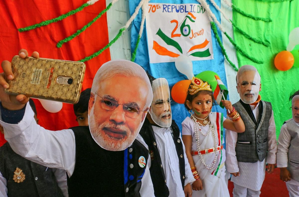Ajmer: Children wearing Prime Minister Narendra Modi's mask take a selfie during Republic Day celebrations, in Ajmer, Friday, Jan. 25, 2019. (PTI Photo)(PTI1_25_2019_000172B)