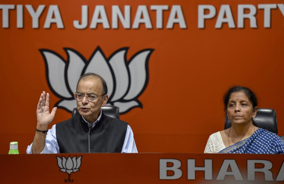 Finance Minister Arun Jaitley addresses a press conference as Defence Minister Nirmala Sitharaman looks on, at BJP headquarters in New Delhi, on Friday. PTI