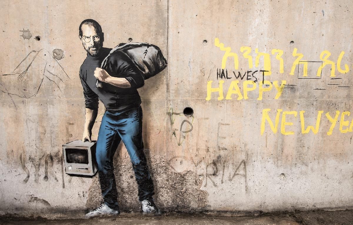 One of Banksy’s iconic murals, Son of a Migrant from Syria, which shows Steve Jobs as a Syrian refugee. Artists like Banksy have helped bring social injustices across the world to the fore.