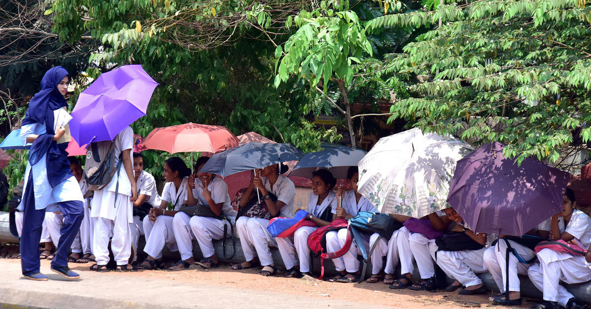 Girls seen using umbrellas and their veils to shield themselves from the unbearable sun in Mangaluru.
