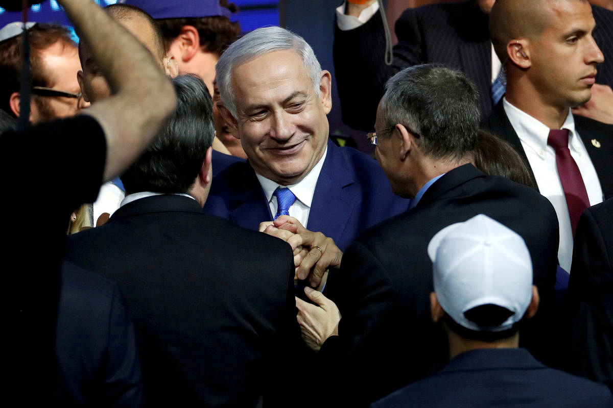 Israeli Prime Minister Benjamin Netanyahu is greeted by supporters of his Likud party as he arrives to speak following the announcement of exit polls in Israel's parliamentary election in Tel Aviv, Israel on April 10, 2019. REUTERS