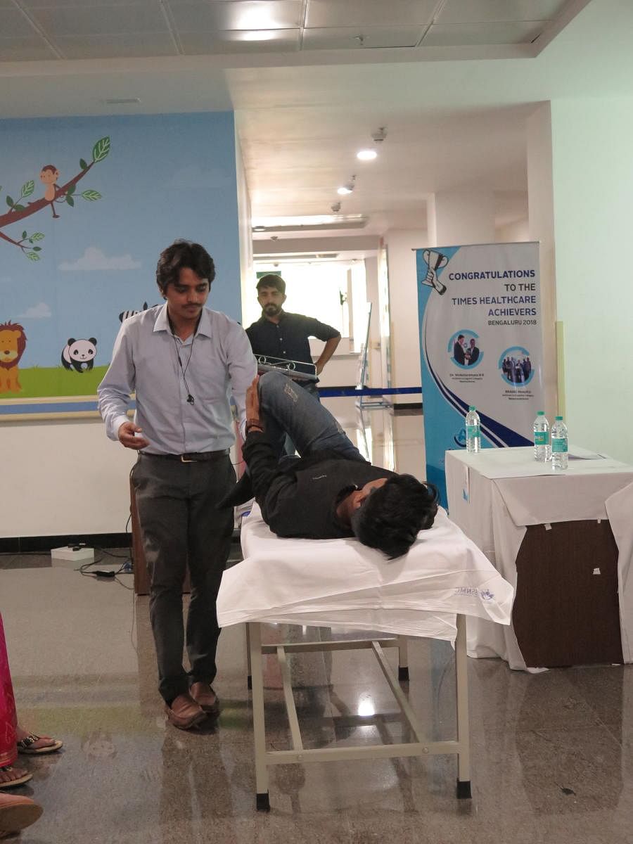 Rahul Dixit (left) and Nikhil K.B., two students from the R.V. College of Physiotherapy demonstrate exercises to ease the effects of Parkinson’s Disease, in Bengaluru on April 11, 2019.