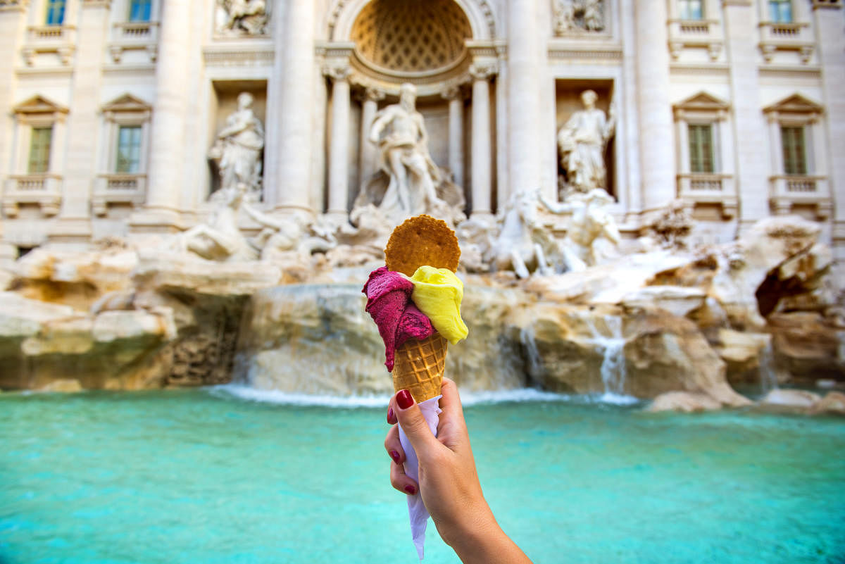 Enjoying gelato at the iconic Trevi Fountain in Rome, Italy