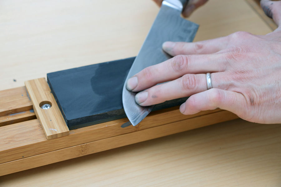 Sharpening a knife with a whetstone. Picture credit: flickr.com/ Didriks