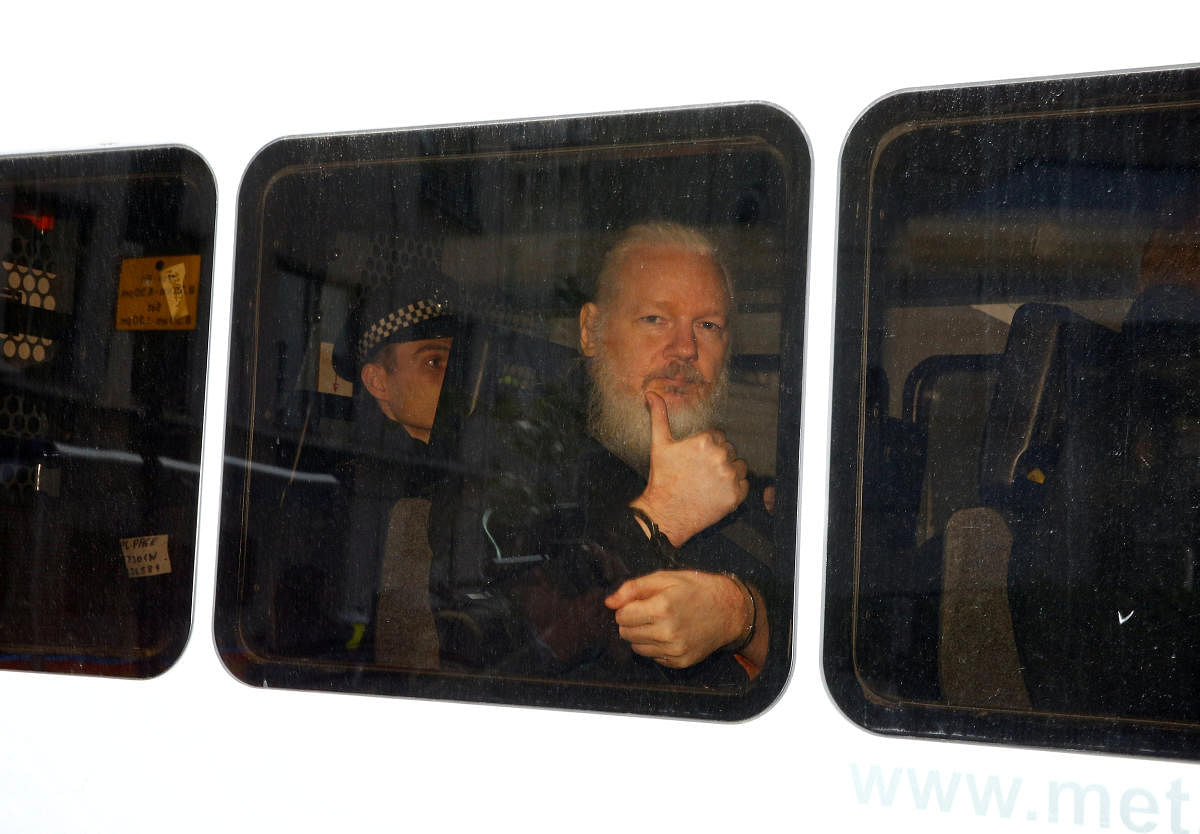 WikiLeaks founder Julian Assange is seen in a police van after being arrested by British police outside the Ecuadorian embassy in London. (Reuters Photo)