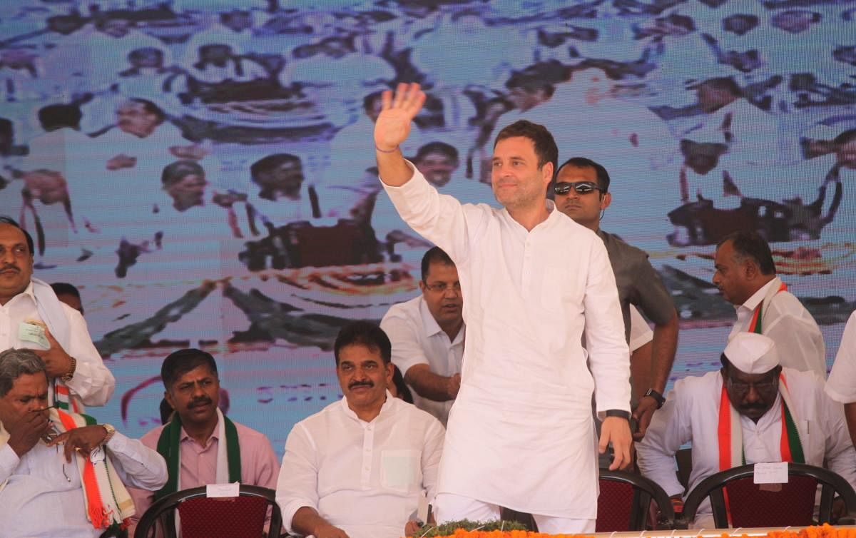 AICC president Rahul Gandhi waves at the crowd during the election rally in Kolar on Saturday. Former chief minister Siddaramaiah and AICC general secretary in-charge of Karnataka K C Venugopal is also seen. DH Photo