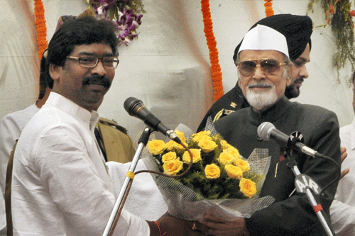 Jharkhand Governor Syed Ahmed greets newly sworn-in Chief Minister Hemant Soren after administering him oath at a ceremony at Raj Bhavan in Ranchi on Saturday. PTI Photo