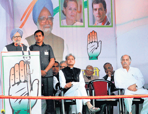 Prime Minister Manmohan Singh addresses an election rally at Ramlila Maidan in Jaipur on Thursday. Rajasthan Chief  Minister Ashok Gehlot is also seen. pti