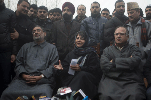People's Democratic Party (PDP) leader Mehbooba Mufti, center, addresses the media at her residence in Srinagar. File photo AP
