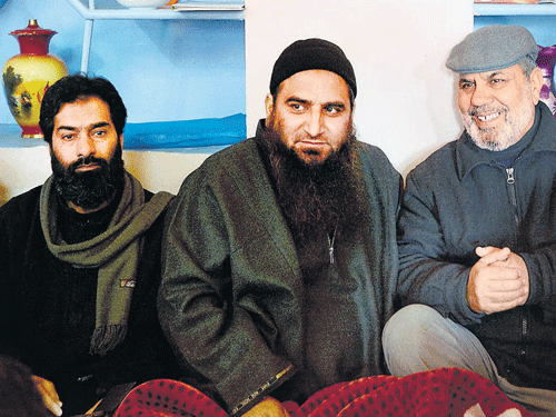 In the eye of the storm: Hardline separatist leader Masrat Alam sits with his associates at his home in Srinagar on  Monday. PTI
