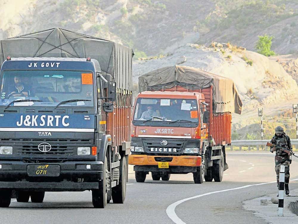 sAFE mODE: Security personnel keep vigil as vehicles loaded with official documents travel to Srinagar during the Darbar Move on the Jammu-Kashmir highway near Ban toll plaza, on the outskirts of Jammu on Sunday. Pti
