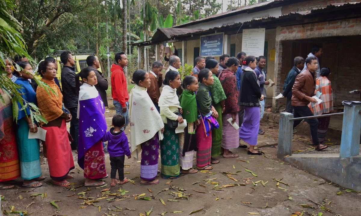 Villagers wait in queues to cast their votes for the state Assembly elections, at a polling station in West Khasi Hills district on Tuesday.