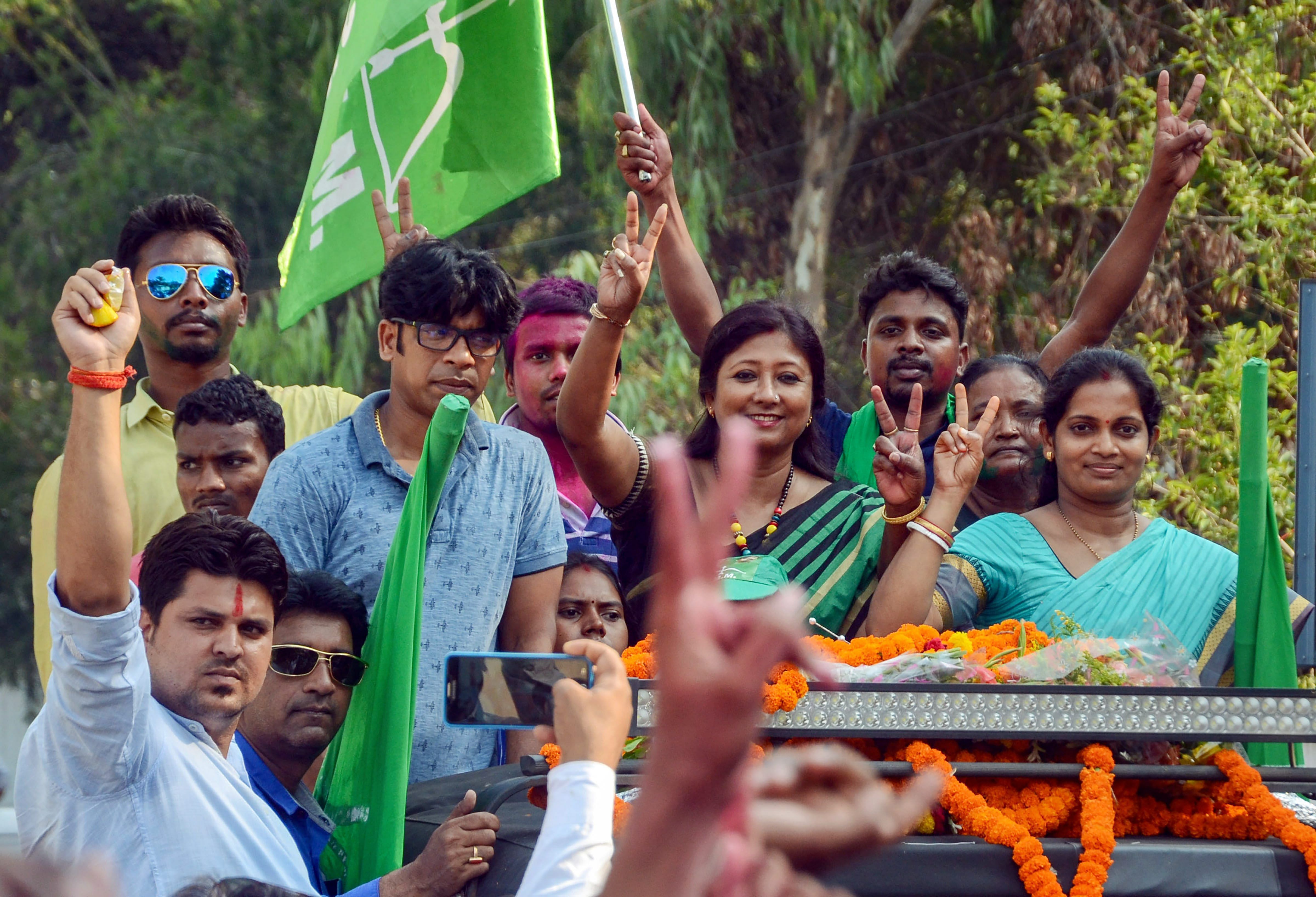 Jharkhand Mukti Morcha candidate Seema Mahato with her supporters flashes a victory sign during the victory procession after winning the Silli constituency seat, in Ranchi, on Thursday. PTI