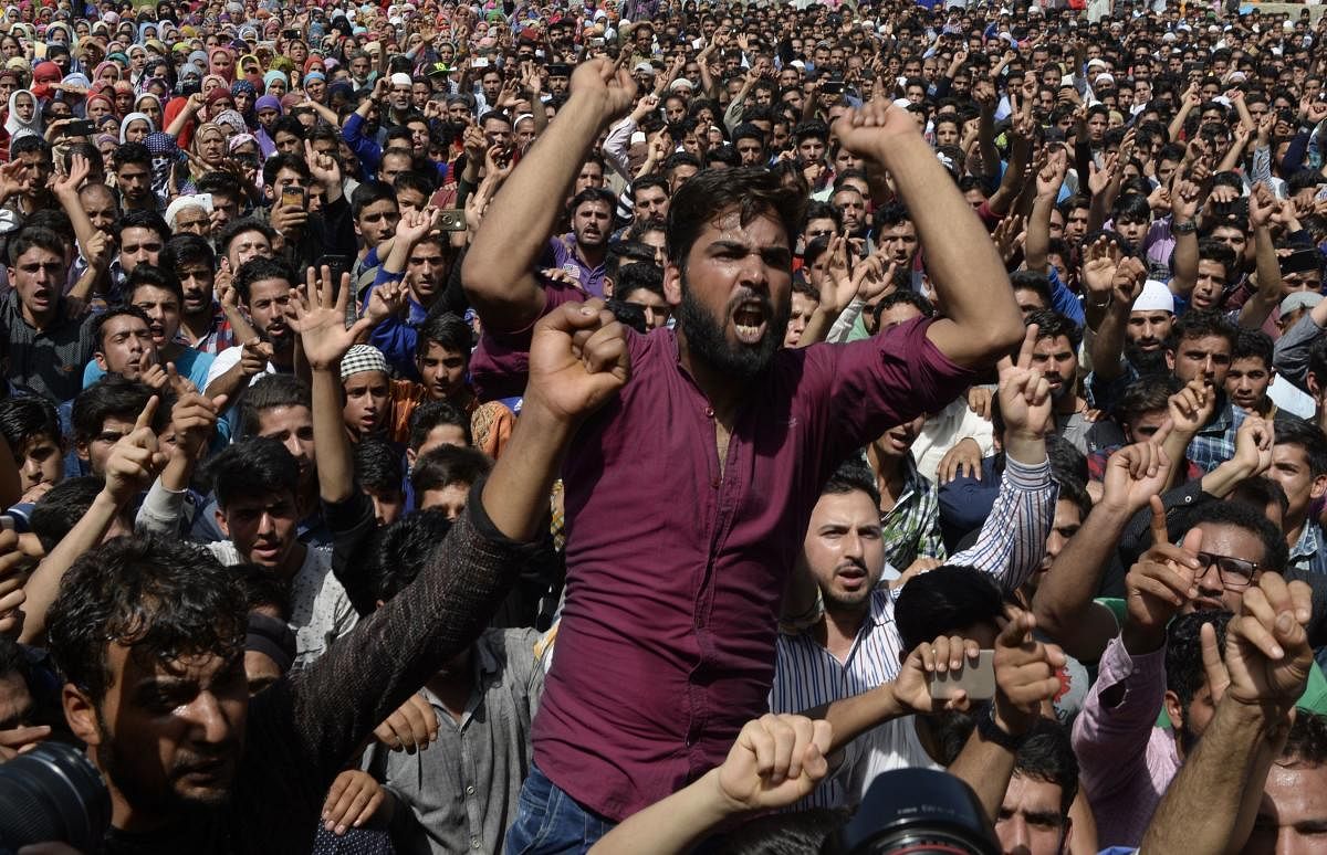 Kashmiri villagers schouts during a funeral procession of a two youths including a teenage girl at Kulgam, south of Srinagar on July 7, 2018. Troops shot dead three stone-throwing protesters including a 16-year-old girl in Kashmir.