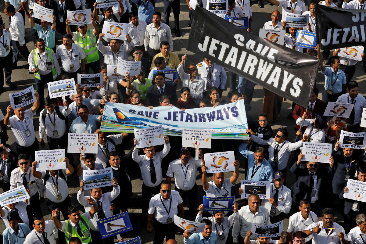 Jet Airways employees hold placards and banners during a protest demanding to "save Jet Airways" at the Indira Gandhi International Airport in New Delhi, India, April 13, 2019. REUTERS