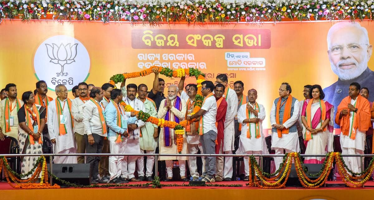 Prime Minister Narendra Modi being garlanded by party leaders during Vijay Sankalp Sabha, an election campaign for the Lok Sabha polls, in Bhubaneswar, Tuesday, April 16, 2019. PTI