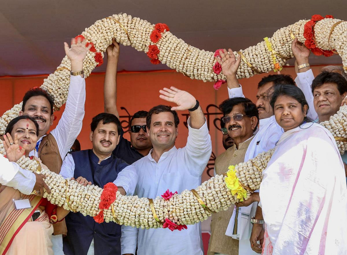 Congress President Rahul Gandhi being garlanded during 'Jan Bhawna Rally', in Purnia, Saturday, March 23, 2019. (PTI Photo) 