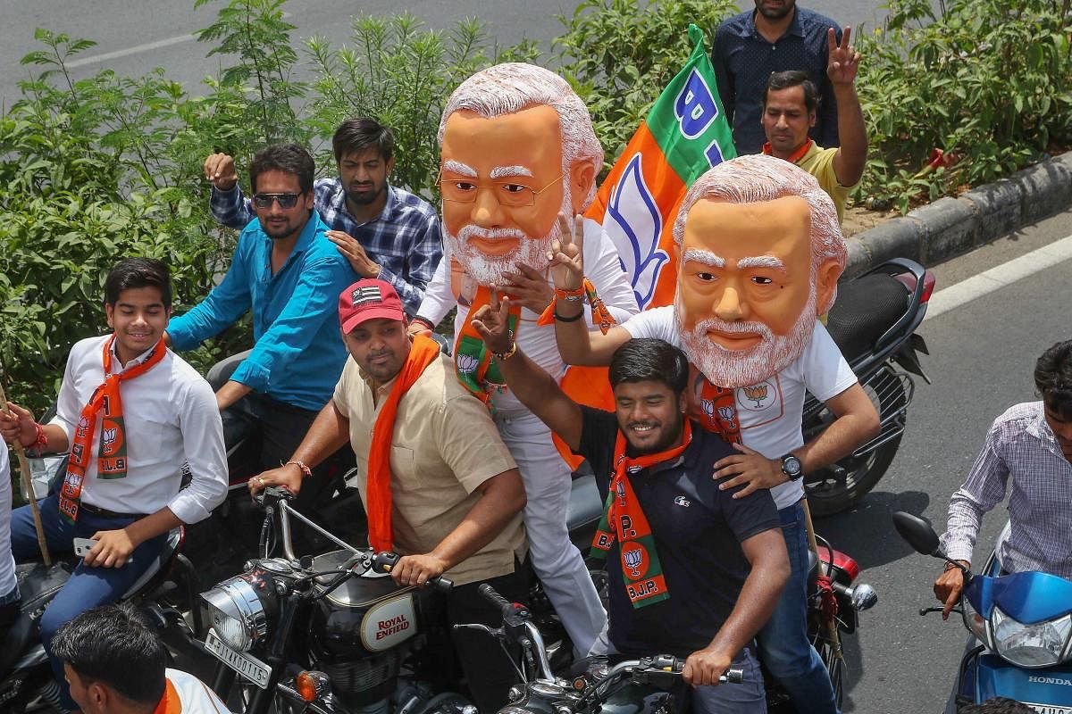 BJP supporters ride on bikes during a rally of party candidate from Jaipur, Ramcharan Bohara, ahead of his nomination filing for the Lok Sabha elections, in Jaipur, Monday, April 15, 2019. (PTI Photo)