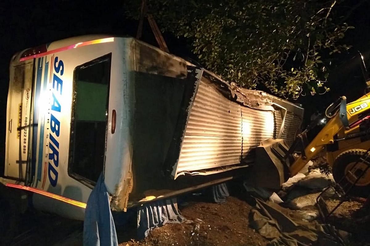 Mangled remains of a private bus that toppled near Ullur in Sagar taluk. DH Photo