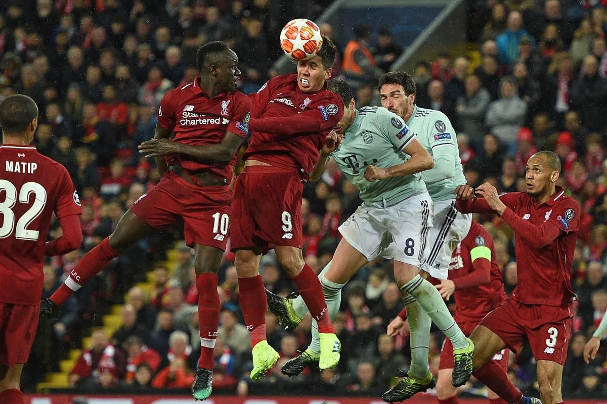Liverpool's Roberto Firmino (second from right) wins a header during their clash against Bayern Munich on Tuesday. AFP