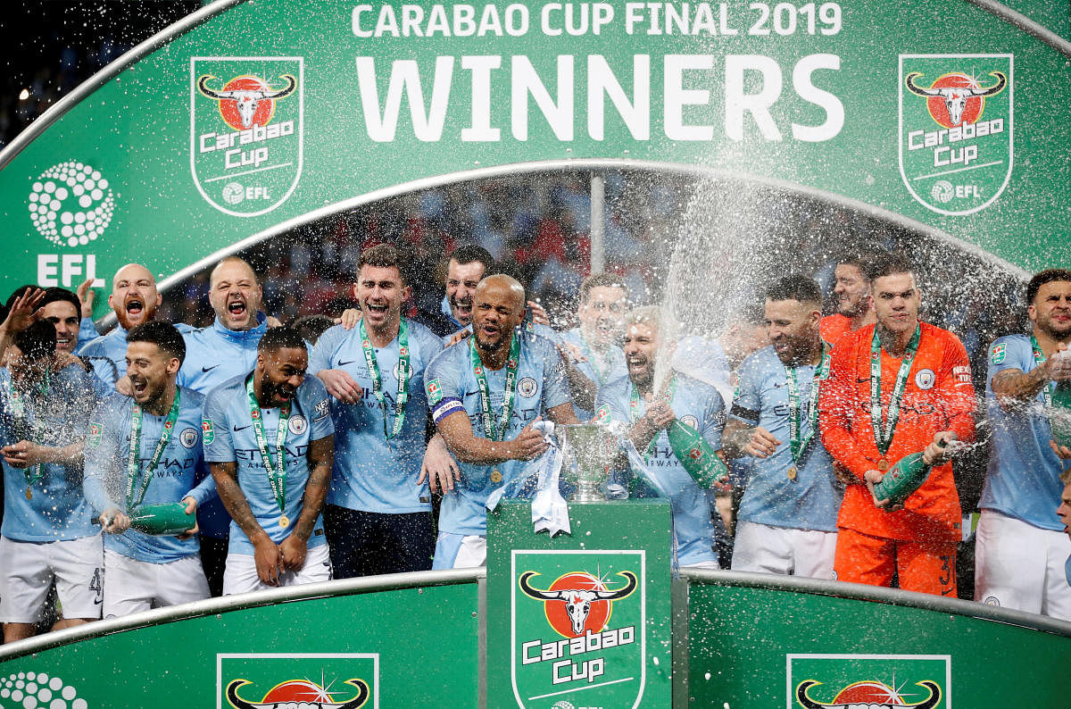 Manchester City players celebrate their victory in the League Cup final on Sunday. They beat Chelsea on penalties. AP/ PTI