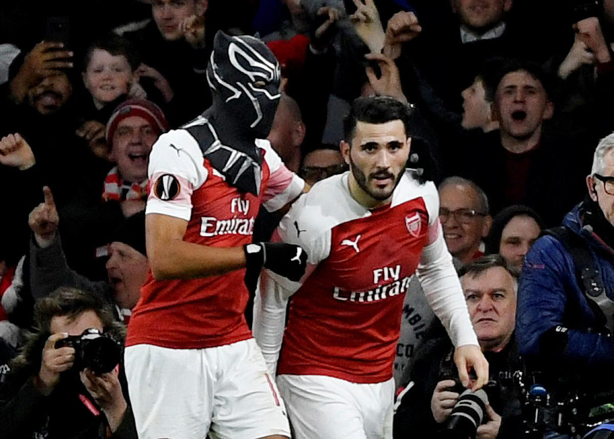 Arsenal's Pierre-Emerick Aubameyang (left) celebrates with the Black Panther mask after scoring against Stade Rennes on Thursday. Reuters
