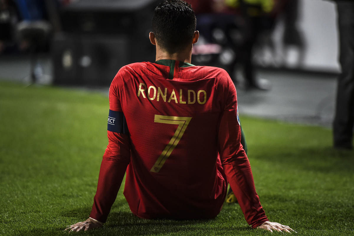 Portugal's forward Cristiano Ronaldo sits on the pitch during the Euro 2020 qualifying group B football match between Portugal and Serbia at the Luz stadium in Lisbon on March 25, 2019. (Photo by PATRICIA DE MELO MOREIRA / AFP)