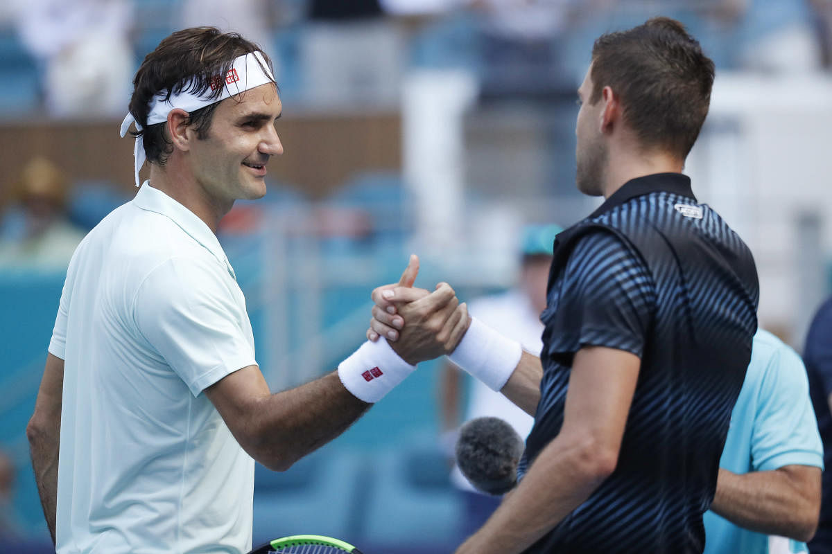 Mar 25, 2019; Miami Gardens, FL, USA; Roger Federer of Switzerland (L) shakes hands with Filip Krajinovic of Serbia (R) after their match in the third round of the Miami Open at Miami Open Tennis Complex. Mandatory Credit: Geoff Burke-USA TODAY Sports