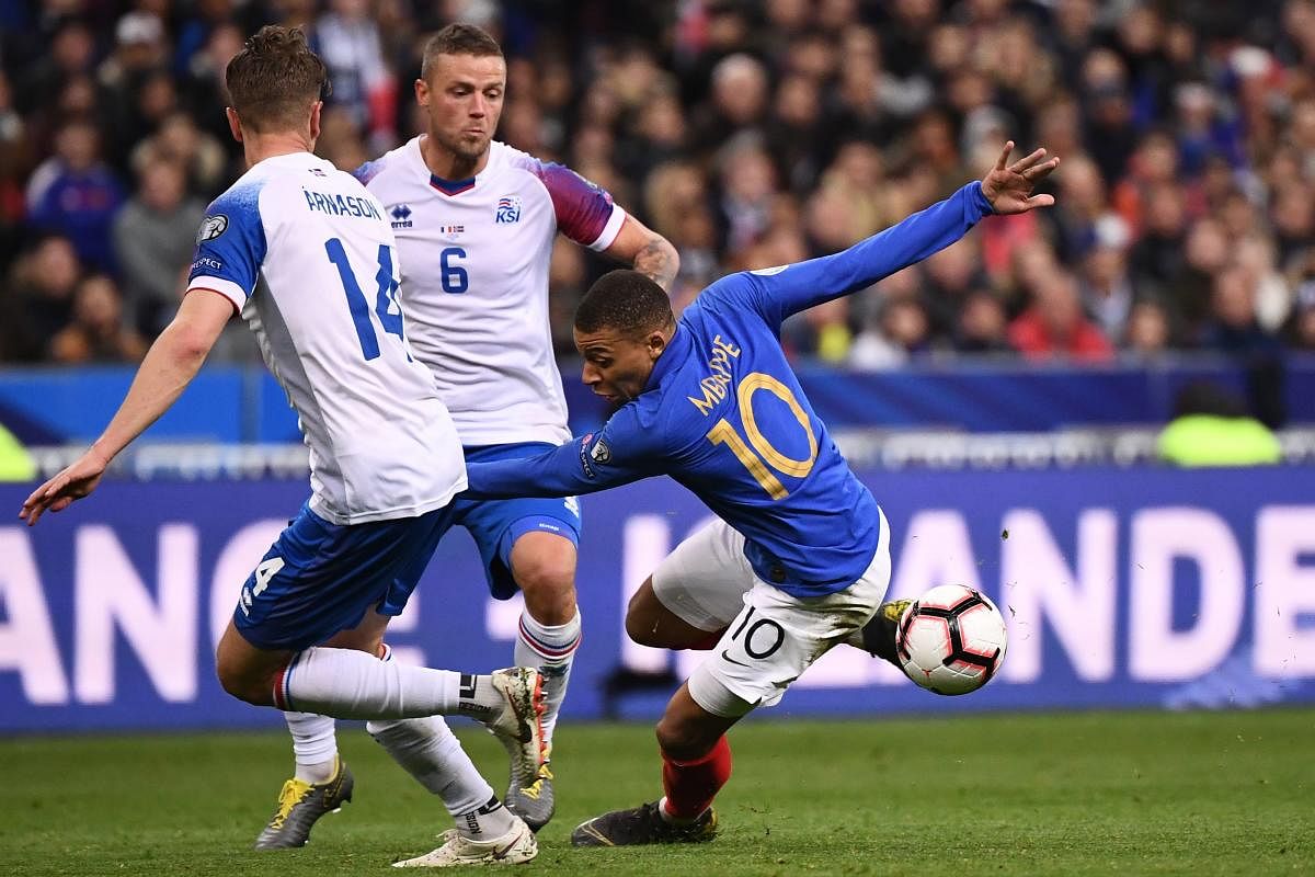 France's forward Kylian Mbappe (R) vies for the ball with Iceland's players during the UEFA Euro 2020 Group H qualification football match between France and Iceland at the Stade de France stadium in Saint-Denis, north of Paris, on March 25, 2019. (Photo