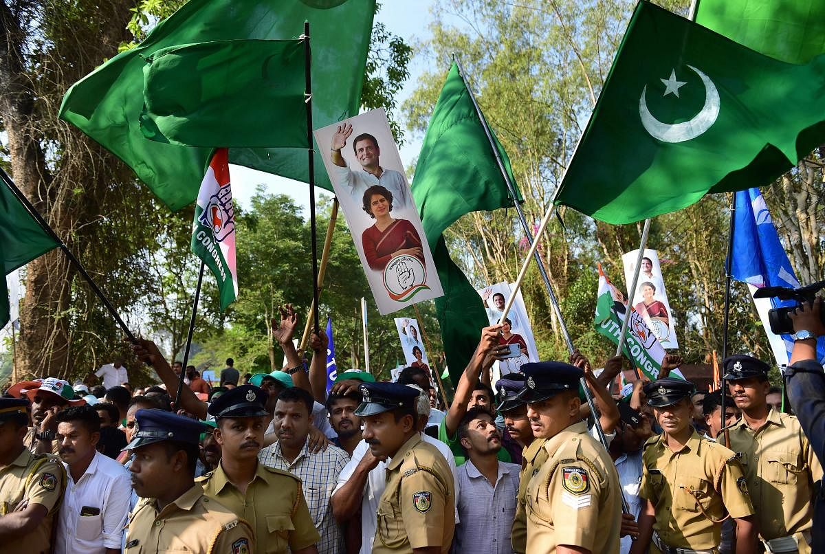 Indian Union Muslim League (IUML) supporters, with green flags, join supporters of Congress as they wave flags prior to the filing of nomination papers by Congress President Rahul Gandhi, in Wayanad on Thursday. PTI