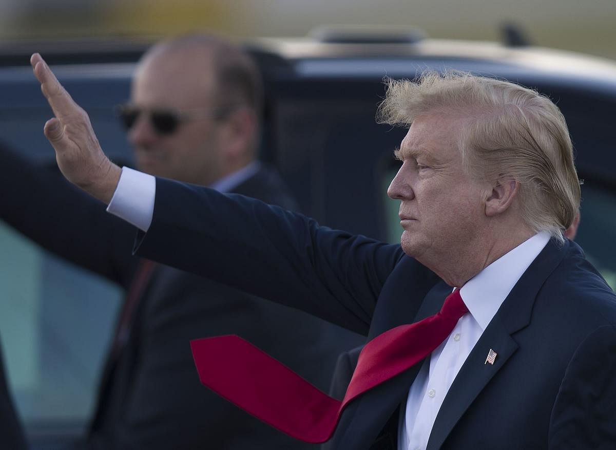 US President Donald Trump waves to supporters after arriving on Air Force One at the Palm Beach International Airport to spend Easter weekend at his Mar-a-Lago resort on April 18, 2019 in West Palm Beach, Florida. (Getty Images/AFP)