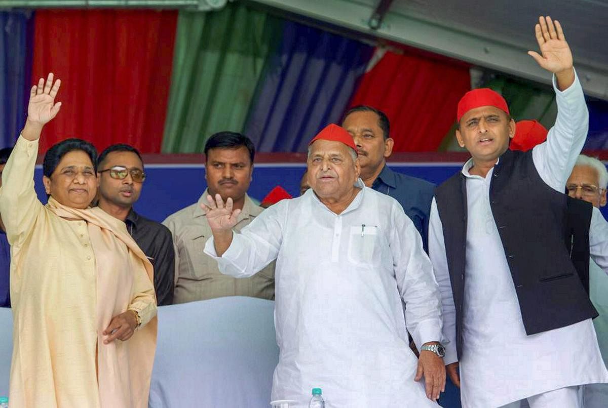 Samajwadi Party patron Mulayam Singh Yadav, his son and party President Akhilesh Yadav and Bahujan Samaj Party supremo Mayawati wave at the crowd during their joint election campaign rally in Mainpuri, Friday, April 19, 2019. PTI