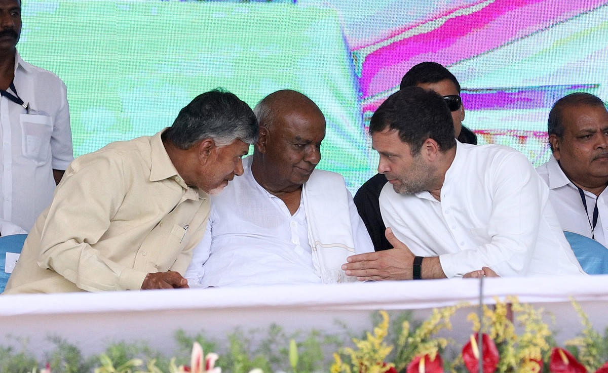 Andhra Pradesh Chief Minister Chandrababu Naidu, JD(S) supremo H D Deve Gowda and Congress president Rahul Gandhi share a word with each other during the election rally in Raichur on Friday. DH Photo