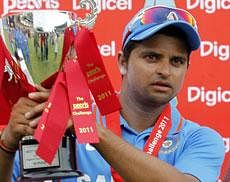 India's limited-overs captain Suresh Raina lifts the the trophy during the presentation of the fifth one-day international cricket match in Kingston, Jamaica, Thursday. AP