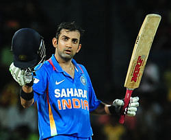 Gautam Gambhir raises his bat and helmet in celebration after scoring a century during the third one day international (ODI) match between Sri Lanka and India at the R. Premadasa Cricket Stadium in Colombo on Saturday. AFP