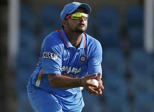 India's Suresh Raina takes the catch to dismiss West Indies opening batsman Johnson Charles for 45 runs during their Tri-Nation Series cricket match in Port-of-Spain, Trinidad, Friday, July 5, 2013. (AP Photo/Andres Leighton)