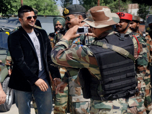 Cricketer Suresh Raina interacting with Army officials before inaugurating a cricket tournament organised by the Army at Degree College in Baramulla on Sunday. PTI Photo