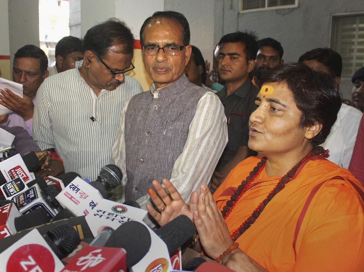 BJP candidate for Bhopal Lok Sabha seat Sadhvi Pragya Singh Thakur, with BJP vice president Shivraj Singh Chouhan, addresses a press conference at the party's state headquarters in Bhopal, Wednesday, April 17, 2019. BJP has fielded Thakur, an accused in the 2008 Malegaon blasts, as its candidate against Congress leader Digvijay Singh. (PTI Photo)