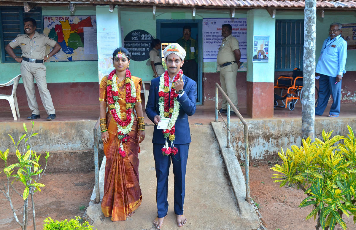 Newly-wed couple Sandarsh and Anushree after casting their vote at Kodatalu polling booth in Sringeri taluk. DH photo
