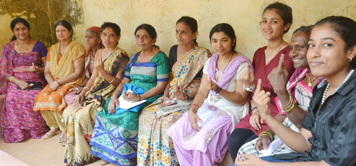 Women voters show inked fingers after casting their votes in the Maoist-infested Vanachalu polling booth in Madikeri taluk on Thursday. DH photo