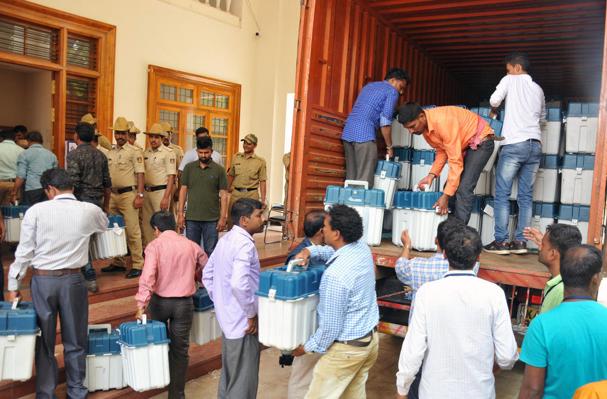 EVMs being shifted to the strong room at Maharani's College in Paduvarahalli, Mysuru on Friday. dh photo