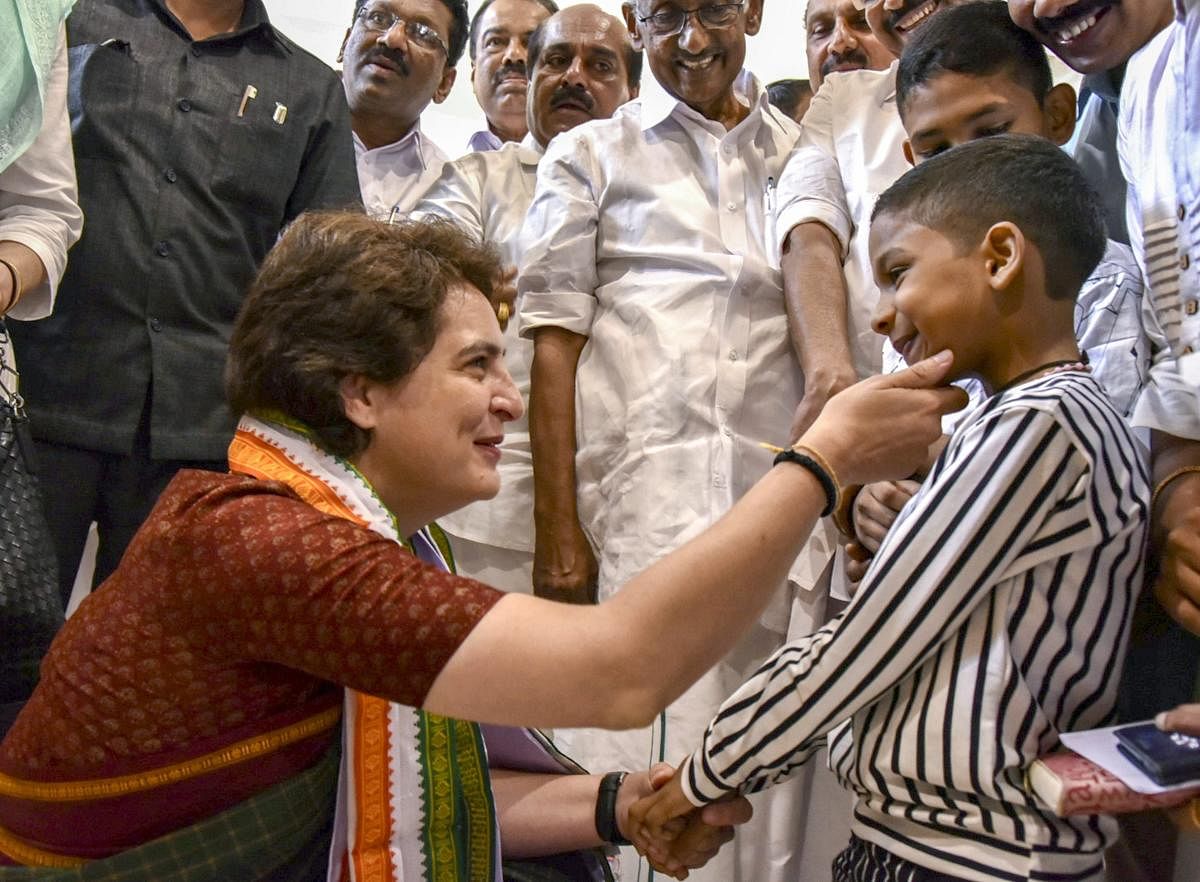 Congress General Secretary Priyanka Gandhi Vadra interacts with Nadhan, the boy who wept over missing a chance to meet Rahul, in Kannur on Saturday | PTI