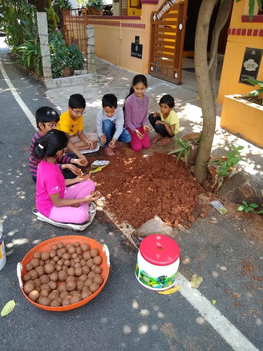 Children preparing seed balls to be planted in Turahalli forest. DH photo