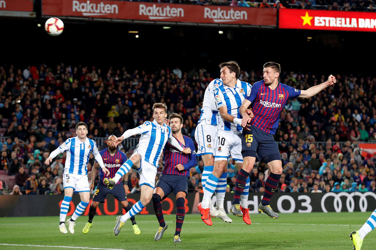 POWERED HOME: Barcelona's Clement Lenglet (right) scores against Real Sociedad on Saturday. Reuters